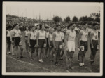 Students from various Jewish schools in Berlin gather to sing Hatikva at a large track and field event.