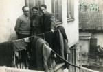 Three members of the Paper Brigade pose together on a balcony in the Vilna ghetto.