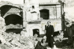 Avraham Sutzveker stands in front of the ruins of the ghetto school in Vilna.