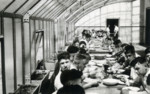 A group of boys gathers for a meal in the dining hall of a children's home in Aische en Refail.