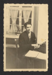 A Polish Jewish displaced person is seated at a typewriter at the Schwaebish Hall DP camp

Pictured is Mayer Spiro.