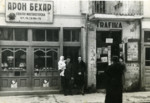 A Jewish couple with their baby daughter, in front of their electrical goods store.