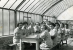 A group of girls gathers for a meal in the dining hall of a children's home in Aische en Refail.