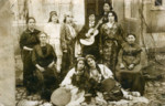 A group of women pose together, some holding musical instruments.