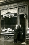 A Jewish couple stand outside their store in Paris.