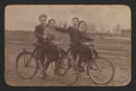 Sisters Chaya Markman (right) and Genia Markman (left) seated on bicycles, with two unidentified companions standing behind them, Parafianov, Poland (now Belarus), April 18, 1938.