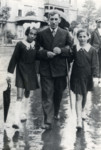 Nachman Weber (brother-in-law to Henryk Graubart) and his twin daughters, Irka and Frieda, walk down the street in Warsaw.