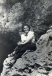 Bella Finkelstein (wife of Kuba Weber) sits on a rock outcropping.