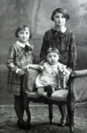Studio portrait of three Dutch Jewish sisters.

Pictured seated is Erna Stopper.
