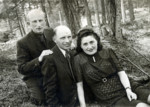 Three displaced persons pose for a photograph in the woods near the Dachau D.P.