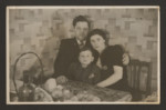 A Belgian Jewish family sits together at a dining tabe.