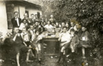 Group portrait of  Noar Hazioni summer camp partipants seated around a table.