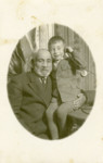 Studio portrait of a Polish Jewish child and his grandfather.