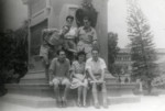 A group of friends pose in front of a monument in the garden of  the Prince of Wales Museum in Bombay, on V-E Day.