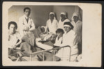 Dr. Ladislav Merei and a group of nurses gather around a patient in prewar Czechoslovakia (either Prague or Bratislava).