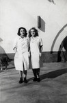 Two Jewish girls stand in the courtyard of the jail in Bucharest.