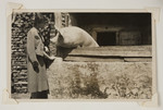 Maria Bloch-Bauer poses next to a pig on an unidentified farm,