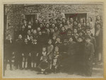 Group portrait of men, women and children in the Barbizon displaced persons camp in France.