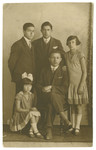 Portrait of the Meirtal siblings.

Pictured standing left to right are Peisach, Hirsch, and Deborah-Miriam; seated are Isaac and Shein-Chinde.