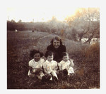 Dora Teitelbaum poses in a field with her three young daughters, Bertha, Malka and Bella.