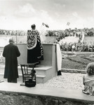 A priest leads prayers during the dedication of the monument to the victims of the Pocking concentration camp.