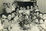 Hannah (child top right) and her parents Zvi and Ida Szklut attend a birthday party with lots of young toddlers [probably in the Bergen-Belsen displaced persons camp].