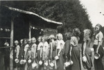 Young girls wait in line with their lunch pails in a summer camp in Czechoslovakia.