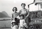 Toni Ermann poses on the shore of Lake Lugano with her three daughters.