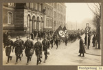Uniformed SA men parade down a city street in Duisburg during a Nazi rally.