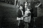 Mirjam Ermann stands behind her sister Suzanne (left) and another young girl in the children's home in Ascona.