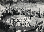 Survivors gather by exhumed bodies of those who  perished at the Pocking concentraion camp before the monument to the victims was created.