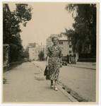 Rifke Zarwanitzer walks down a street [possibly in Bucharest] after the war.