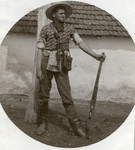 Lajos Weisz stands with a rifle dressed like a cowboy.