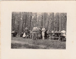 Members of a Hungarin labor battalion stop for lunch at a picnic table.