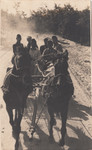 Members of a Hungarian labor battalion ride in a horse drawn cart.
