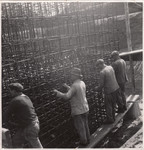 Members of a Jewish labor battalion install a metal grid at a construction site in Hajduhadhaz.