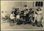 Teachers supervise children from the Nos Petits Jewish kindergarten as they play outside.