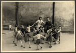Children in the Nos Petits Jewish kindergarten dance in a circle.