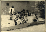Children in the Nos Petits Jewish kindergarten play in the sandbox.