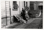 Men wearing armbands pile sand bags outside on the base of the American consulate in Warsaw to protect it from German bombs.