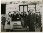 Residents of the Schlachtensee displaced persons' camp bid farewell to the Rothbaums who are leaving for America.