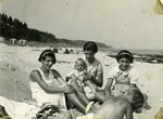 The Oestermann children relax on a beach.

Pictured from left to right are Margot, Else (holding the child of a friend), and Lilian.