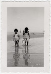Two French Jewish sisters play at the seaside near Merlimont.