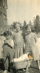 Louis, Inger and Edith pose with their doll in her carriage while visiting their cousins, the Oestermanns.