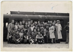 A group of Jewish men and women from the Bergen-Belsen displaced persons camp pose at the train station.