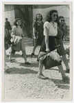 Young women walk down a street of the Eggenfelden displaced persons camp.