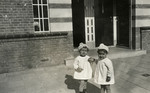 Jewish sisters, Ruth Yetta and Naomi Rivka Tal, pose in front of their family home.