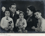 Studio portrait of a Dutch Jewish family. 

From left to right are Ruth, Alexander, Naomi, Frederika and Elchanan Tal.