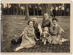 The Liebenau and Olkenitzky families sit on a blanket at the Olkenitzky summer home in Narva Joesuu, Estonia.
