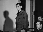 Willi Eckert stands in his place in the defendants' dock at the trial of 61 former camp personnel and prisoners from Mauthausen.
